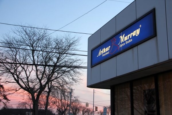 Arthur Murray Dance Studio Merrick NY sunset tree branches store front sign