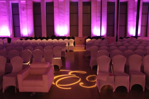 Skybox Productions Philadelphia PA event venue purple lighting seats covered chairs spotlight