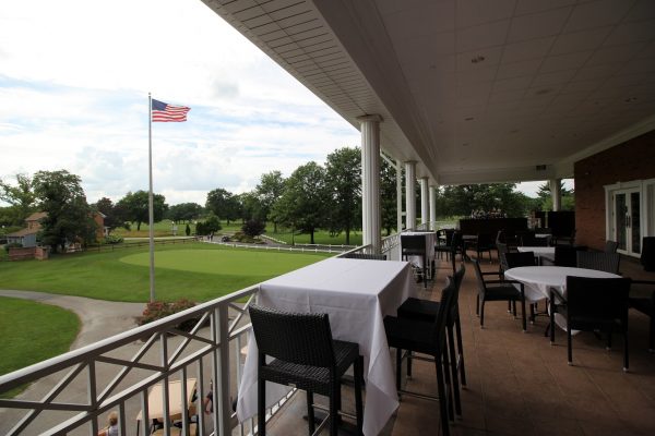 Marco's Restaurant & Banquets outdoor balcony view over Indian Spring golf course and American flag