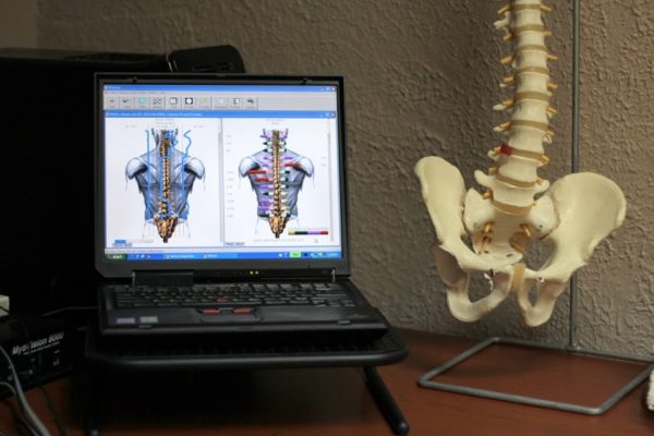 Genesis Chiropractic Clinic Horsham PA back adjustment spine pelvic skeleton model laptop display