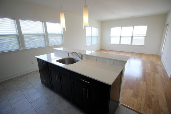 The Collings at The Lumberyard Apartment Complex in Collingswood, NJ kitchen island and living room