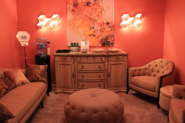 AquaSpa Day Spa and Nail Boutique Marlboro Morganville NJ fancy red waiting room sofa button tufted chair ottoman drawer