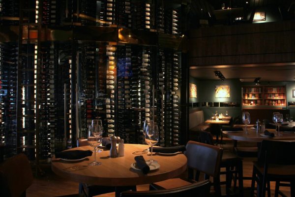 Del Frisco's Grille steak house in Philadelphia, PA dining table with wall of wines