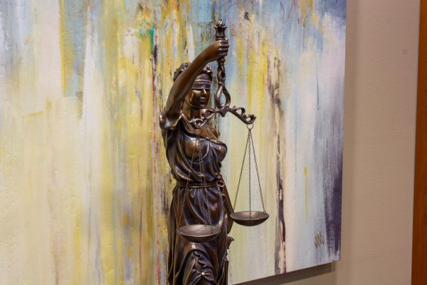statue of Lady Justice holding balance scale at John T. Flood, LLP Personal injury attorney office in Corpus Christi, TX